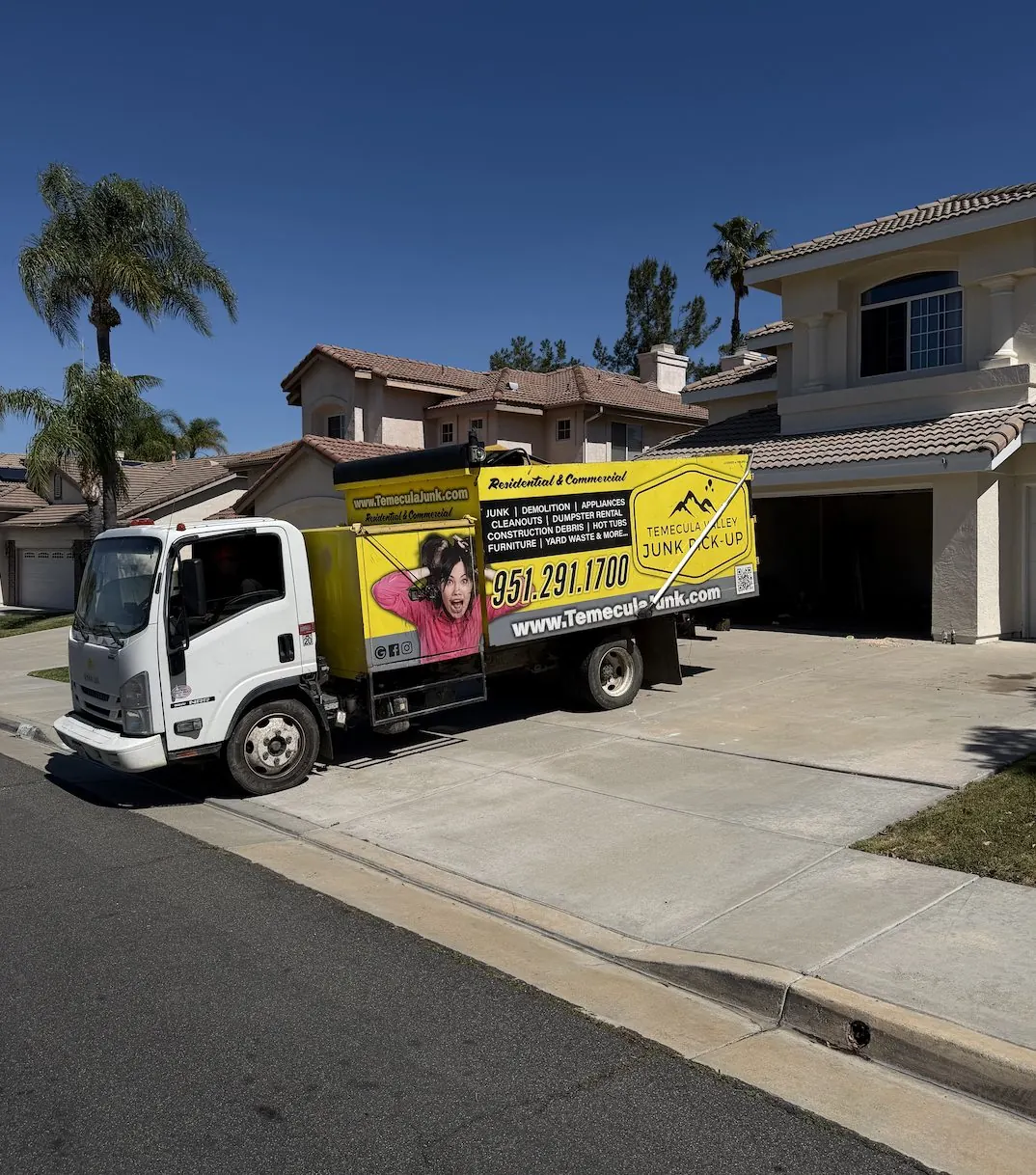 Box truck parked at a home for a junk pickup