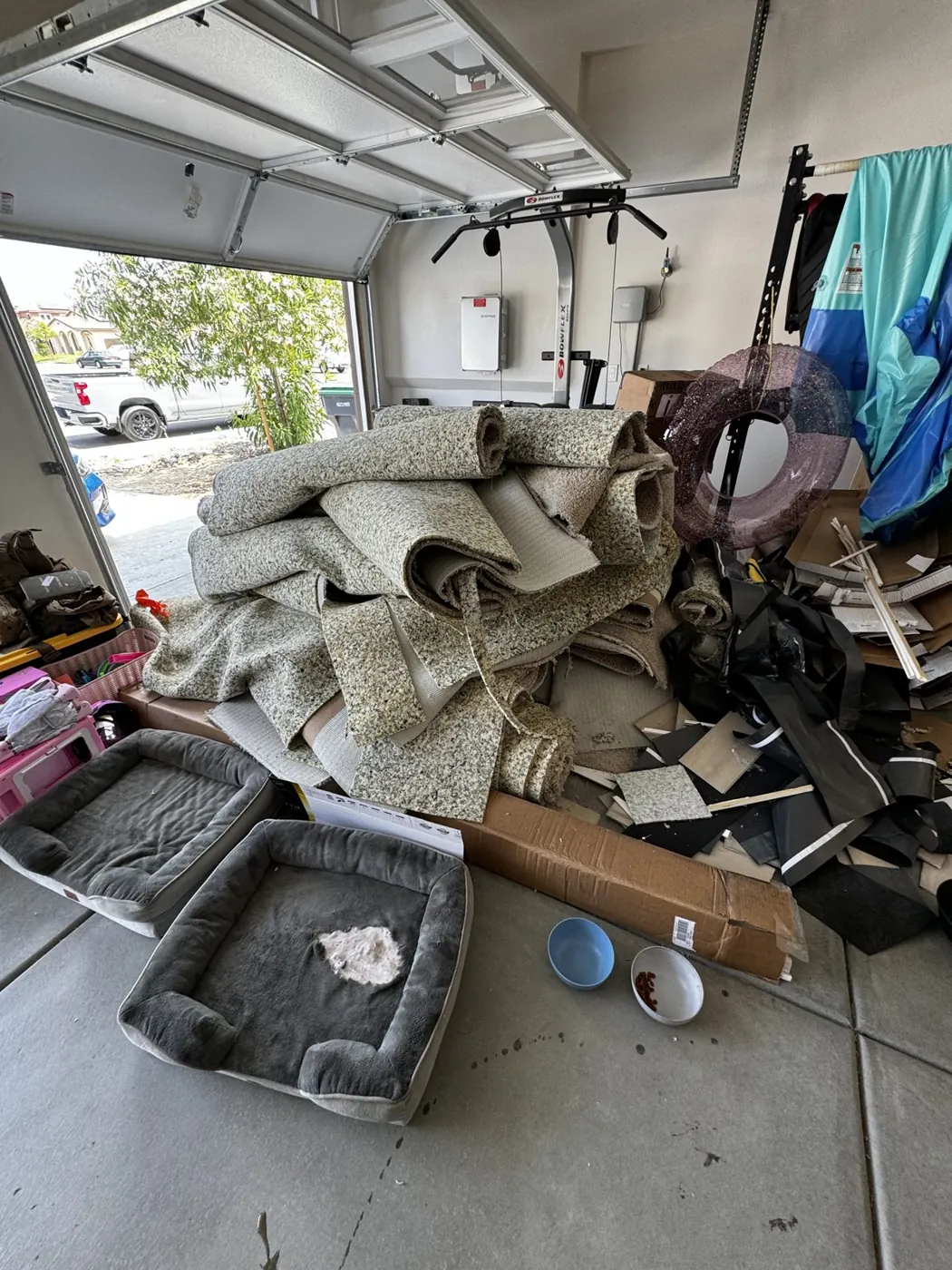 Rolled-up carpet and junk in a garage