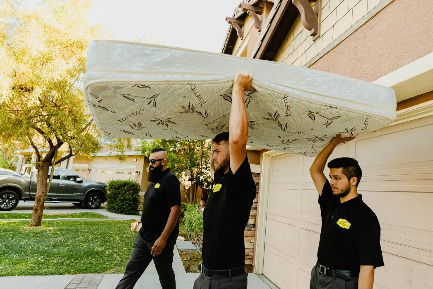 Crew carrying a mattress to the truck