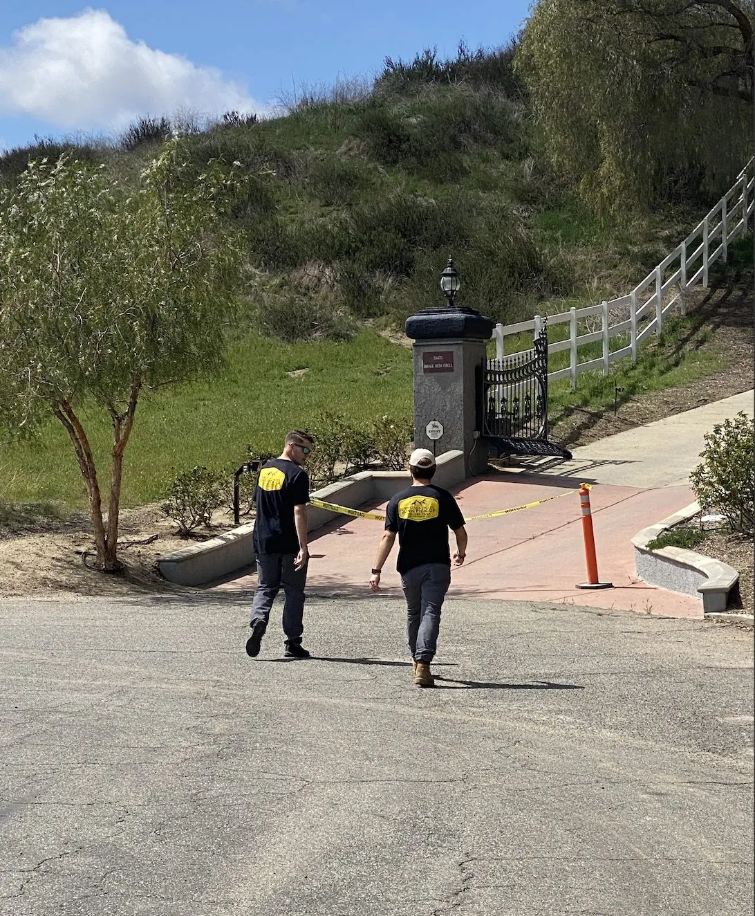 Team walking up a hillside street to a job