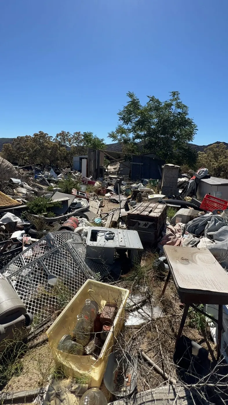 Lot covered in dumped junk