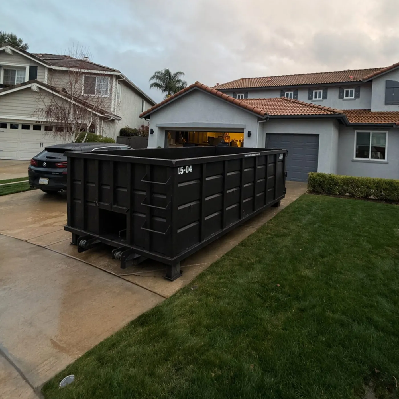 Roll-off dumpster placed in a driveway