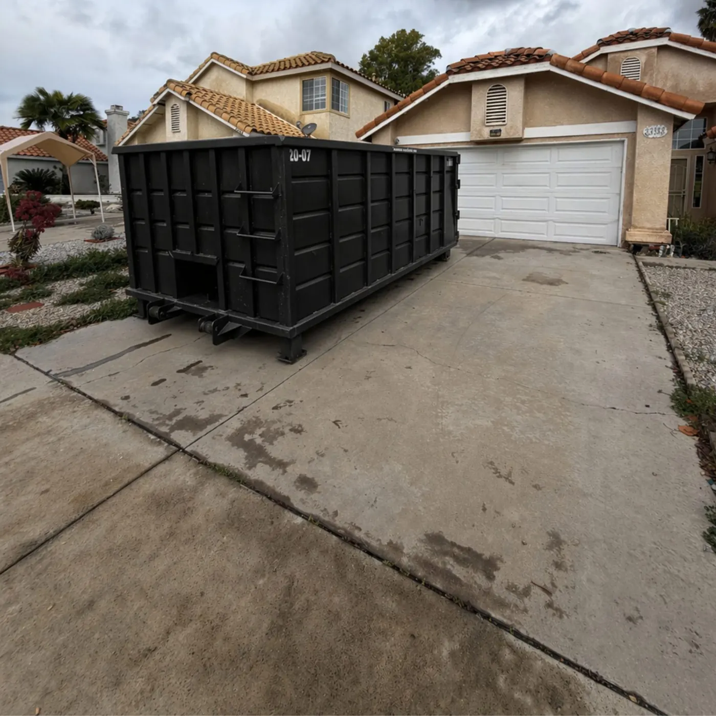 Roll-off dumpster on a residential driveway
