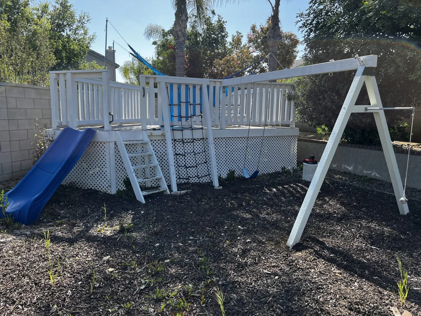 Wooden playset and swing set before removal