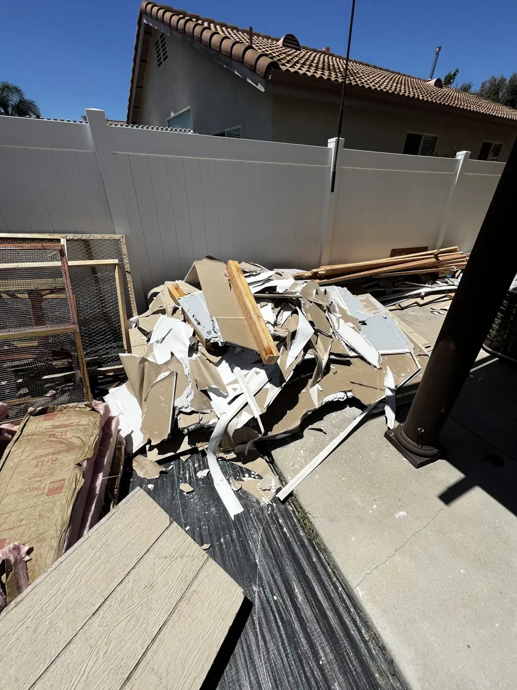 Remodel debris piled in a side yard
