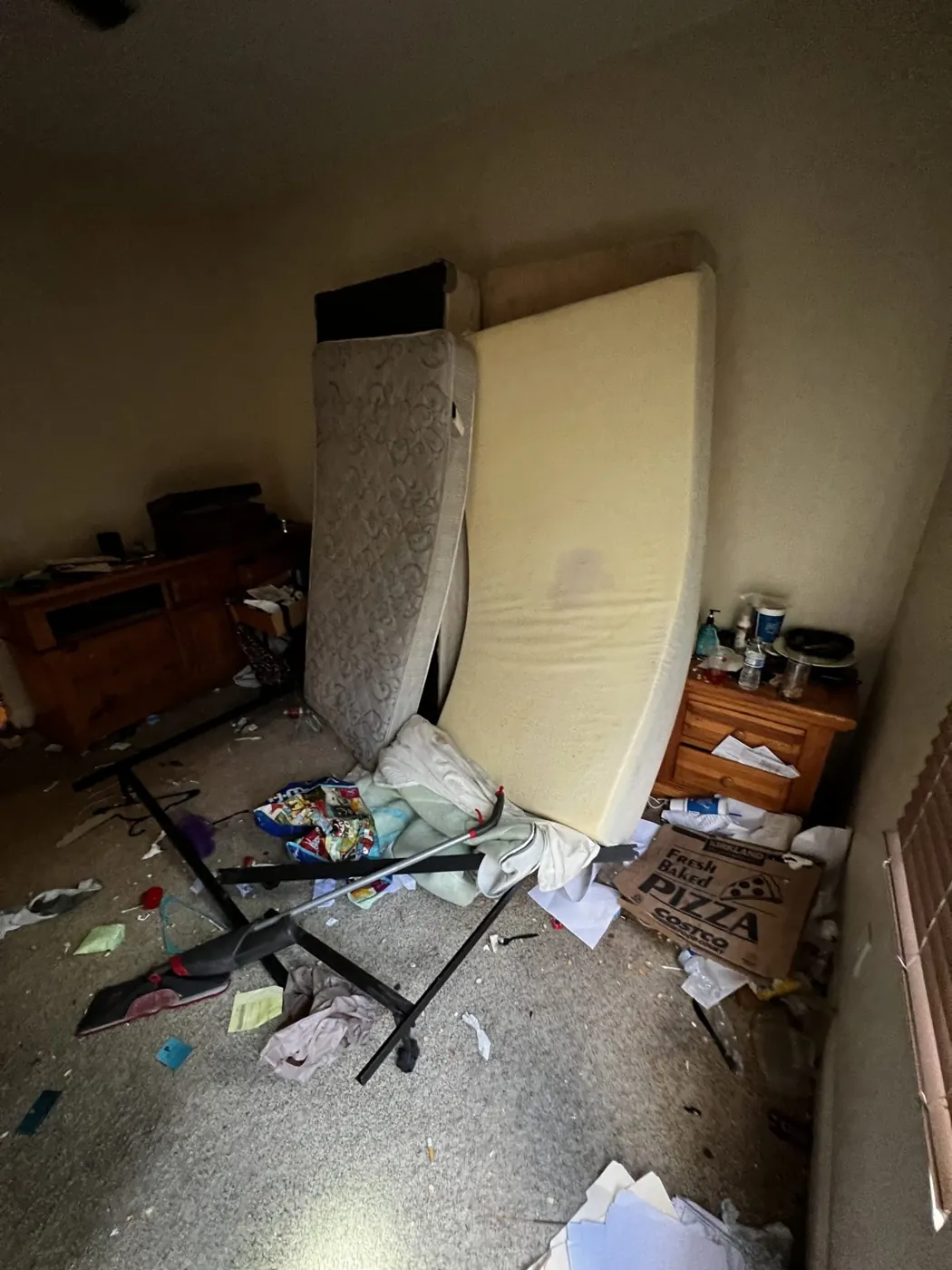 Bedroom left full of trash after a tenant moved out