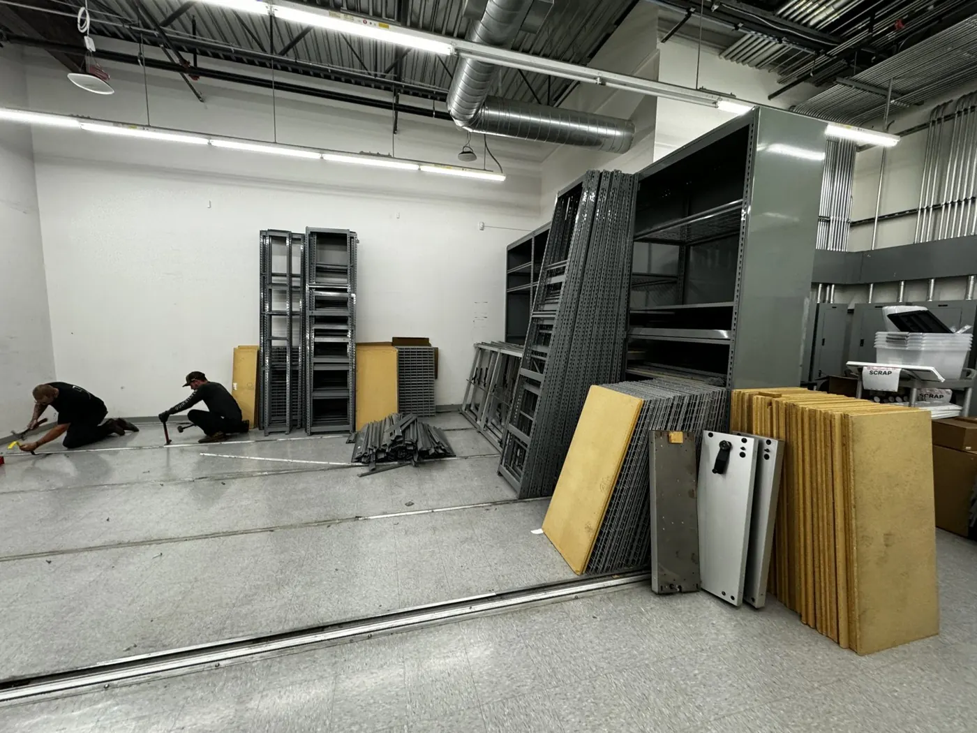 Crew taking down warehouse shelving